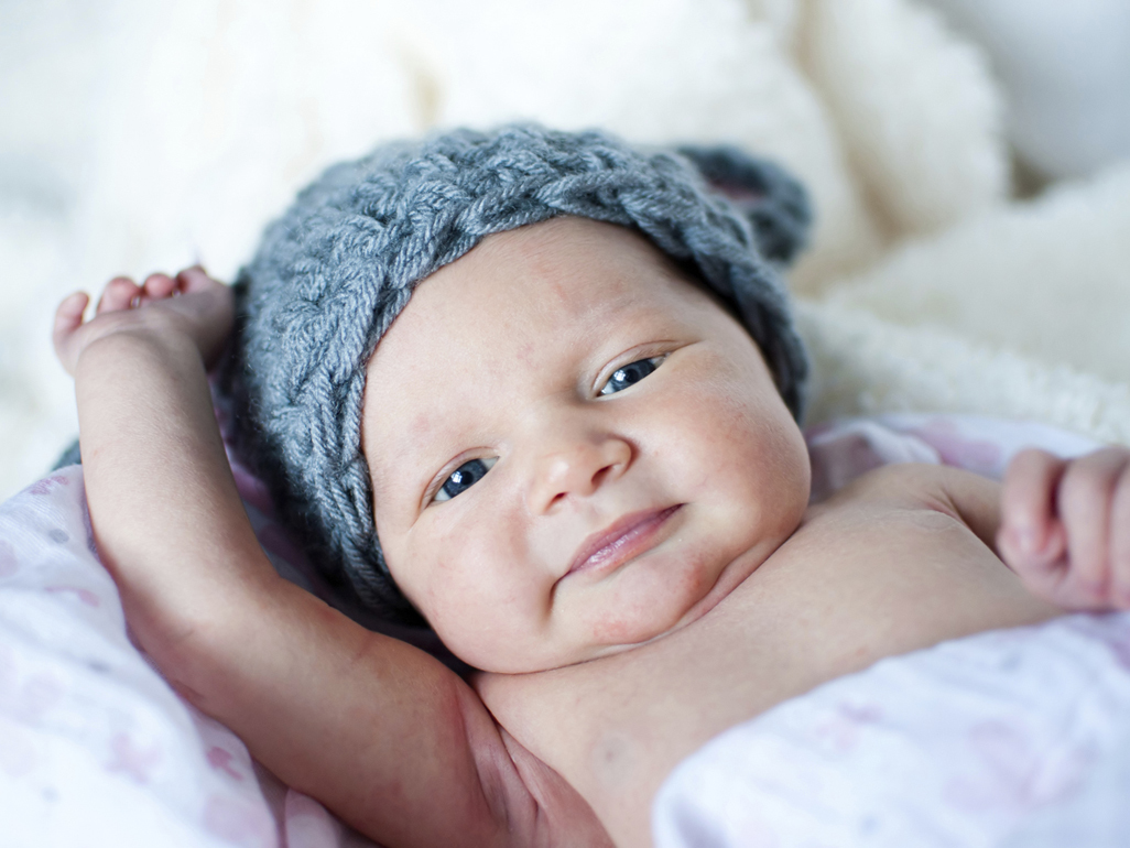 Infant in knitted gray hat