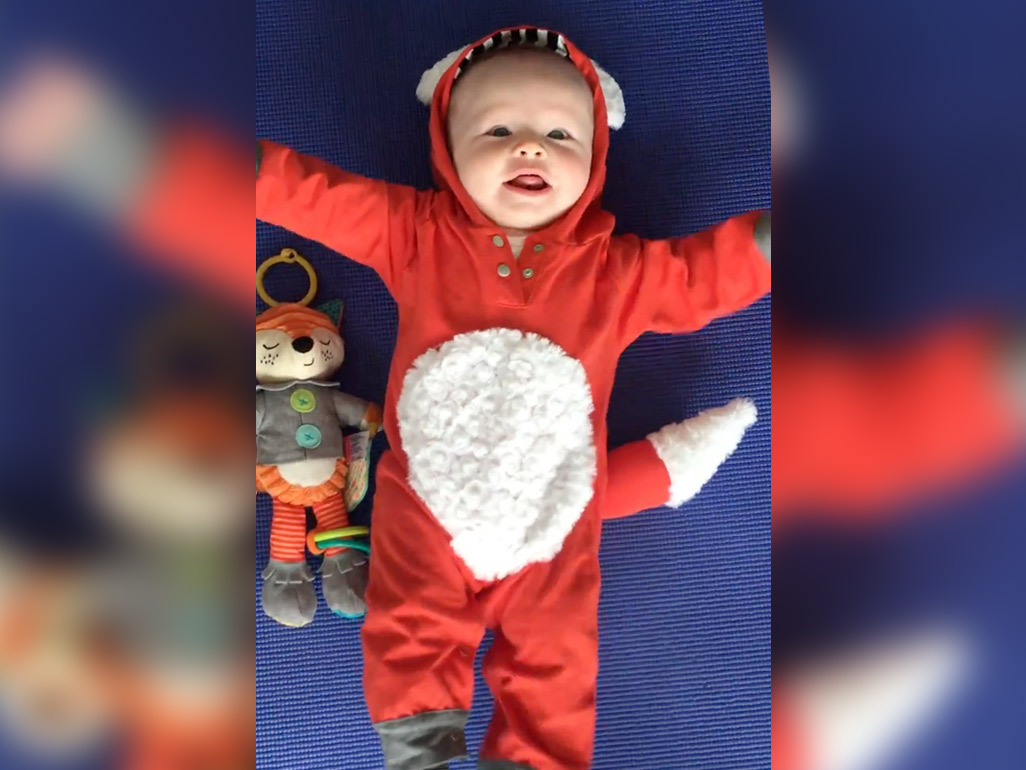 A baby wearing a fox costume