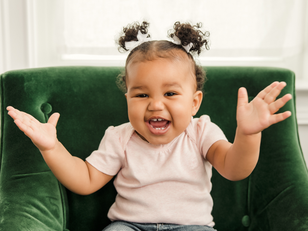 A baby smiling and clapping