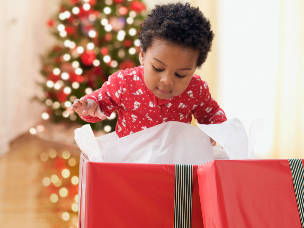 A baby opening a present