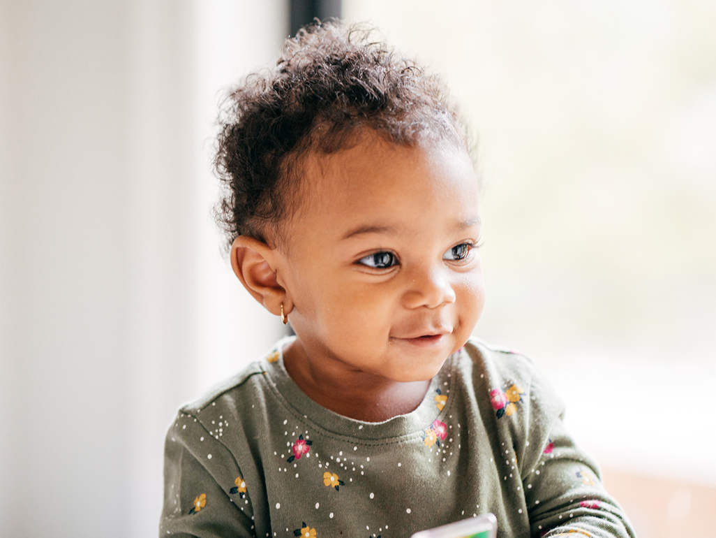 happy curly-haired baby girl