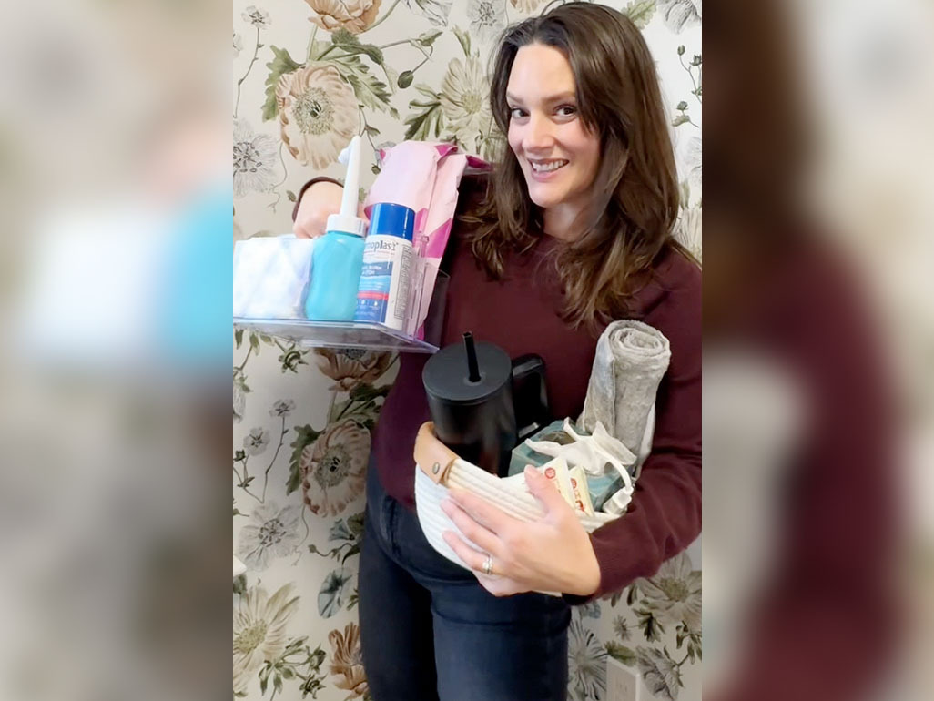 Jaclyn King holding up products she keeps in her postpartum kit