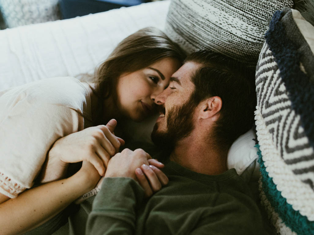 romantic couple lying in bed