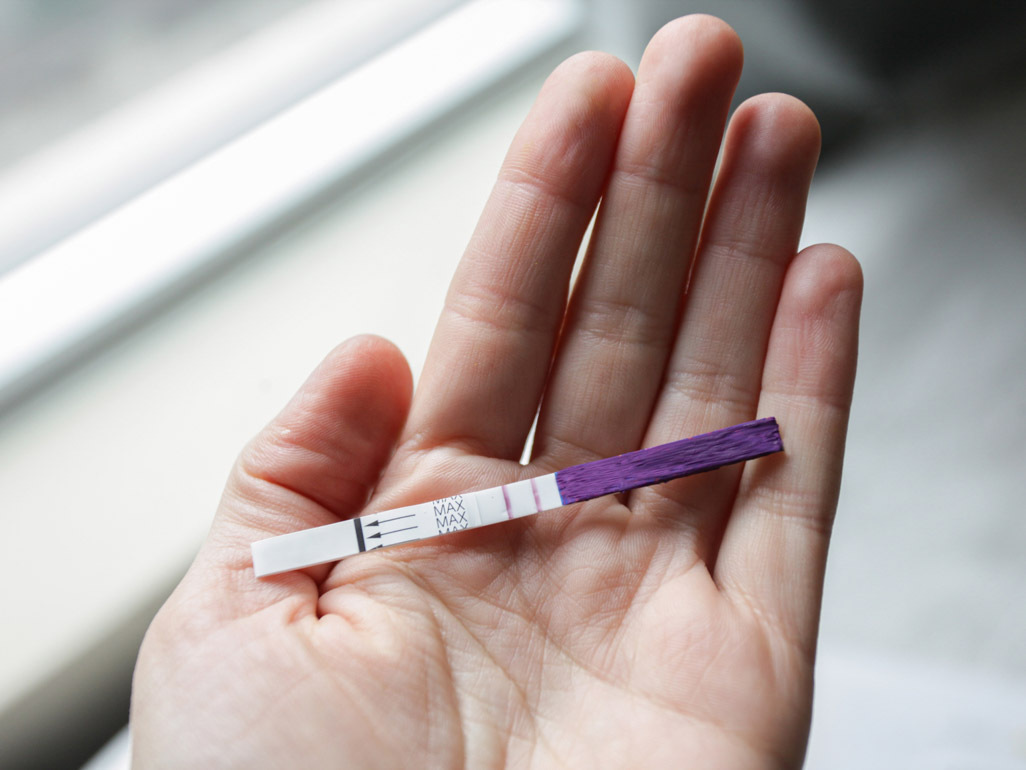 Woman holding an ovulation test strip