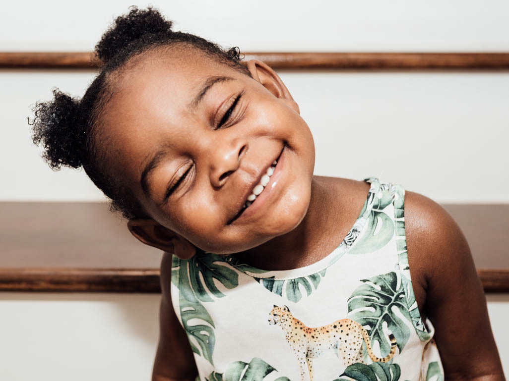 A young Black girl smiling