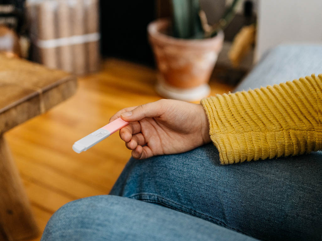 woman holding pregnancy test